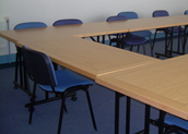 Tables and chairs arranged ready for a meeting