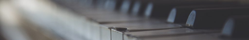 Piano keys, some of which are damaged