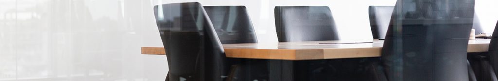 Brown leather chairs surrounding a board room table