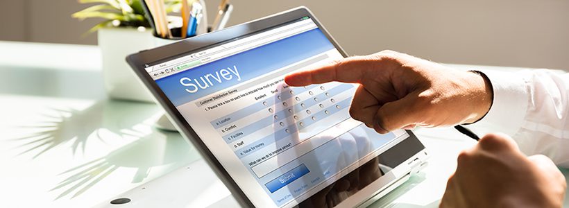 Finger pointing at an on-screen survey